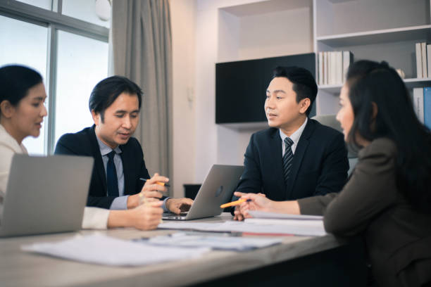 istock Concentrated multiethnic coworker busy using laptop brainstorm sharing thoughts at office meeting 1347906194