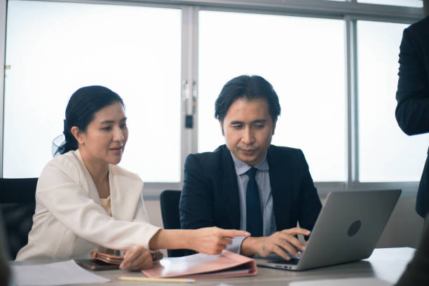 istock Concentrated multiethnic coworker busy using laptop brainstorm sharing thoughts at office meeting 1347906195