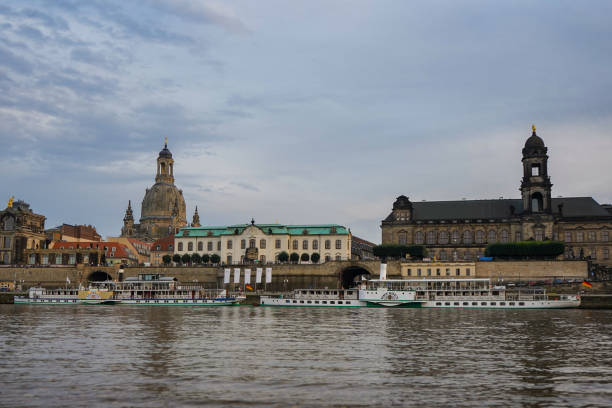 Paddle steamer of the "Weiße Flotte" in Dresden in front of the historic old town Dresden, Germany - August 12 2021: paddle steamers of the Sächsische Dampfschifffahrt on the river Elbe in Dresden. Dresden has the oldest fleet of active paddle steamers in the world. flotte stock pictures, royalty-free photos & images