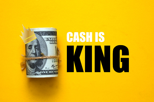 Fake money, illustration of king crown and the word cash is king.