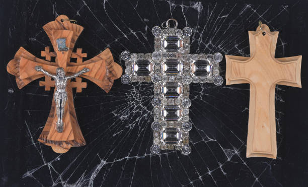 Icon of Jesus on the cross and other religious articles  in a city window, with reflections of city buildings.
