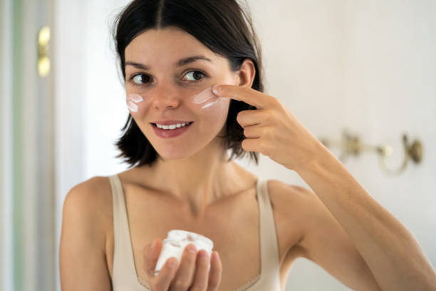 istock Woman applies a moisturizing cream. 1347910565