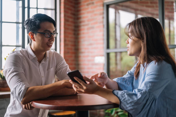 istock Colleagues talking about business strategy with smartphone at office 1347910619