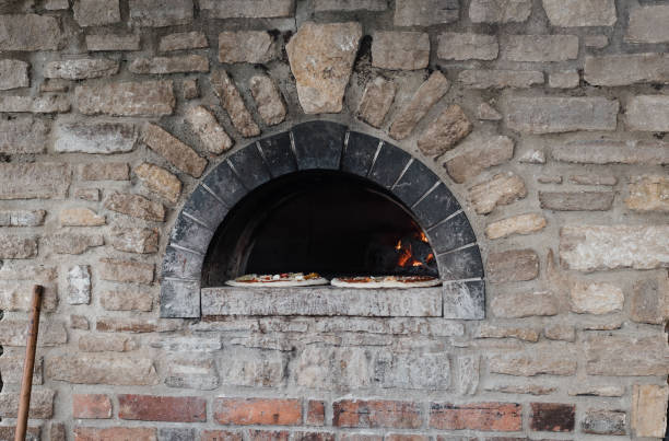 istock stone fired outdoor pizza oven with two pizzas ready to cook 1347910955