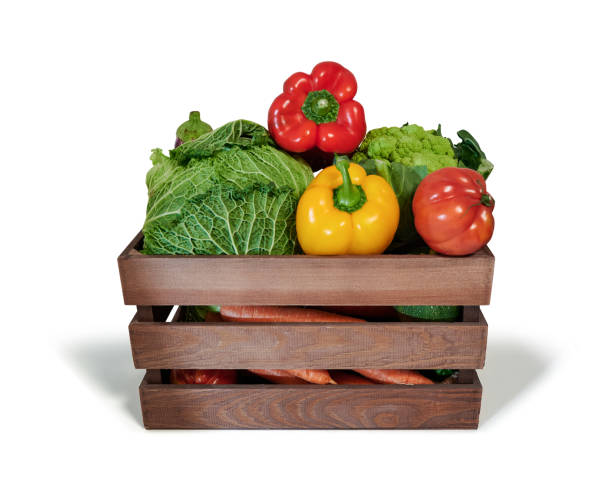 istock Fresh vegetables in a wooden box isolated from white background 1347912342