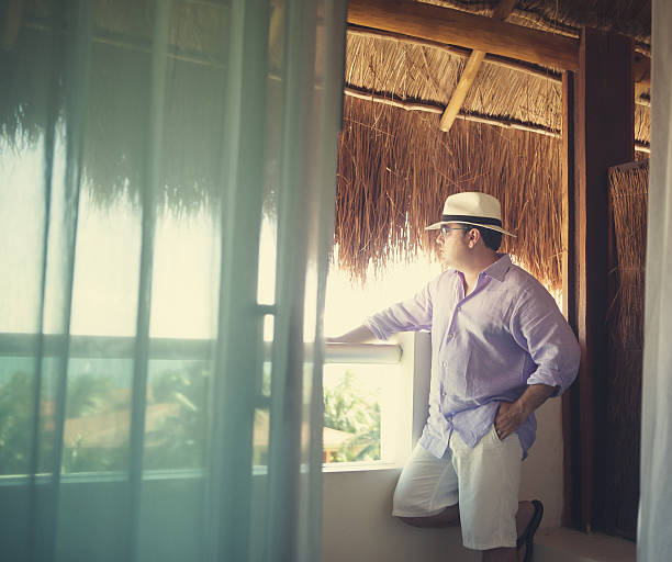 man standing in a balcony stock photo