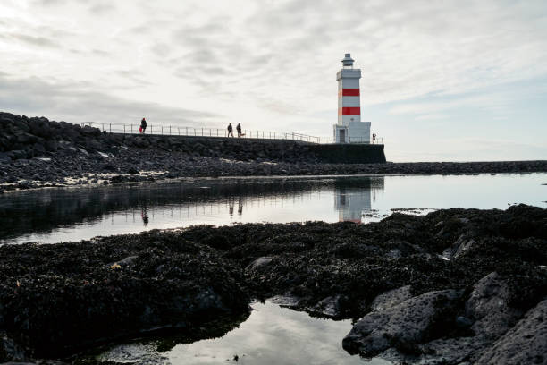 istock Lighthouse on shore near sea 1347912948