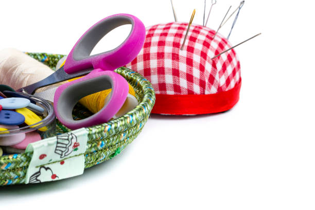 istock Sewing kit from needles, threads, buttons, scissors on white close-up, place for text, copy space. 1347915757