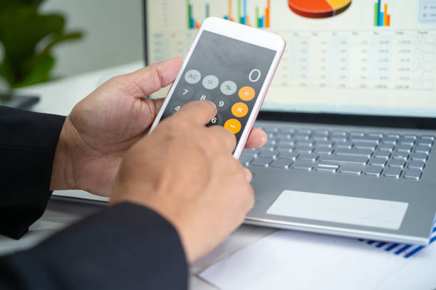 istock Asian accountant working and analyzing financial reports project accounting with chart graph and calculator in modern office, finance and business concept. 1347917389