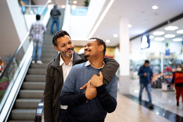 istock Homosexual couple looking at each other at mall 1347918456