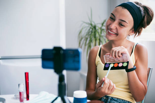 istock Young female vlogger recording a make-up video 1347920890