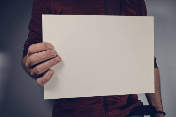 istock Man holding sheet of paper in the hand 1347921404