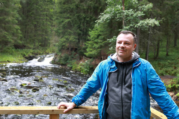 istock Man posing in park valley of waterfalls 1347921461