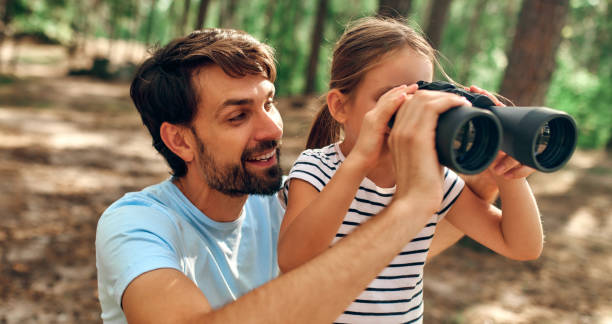 istock Family with dog in the forest 1347923768