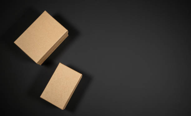 istock Wrapped vintage gift boxes with red ribbon bow, isolated on black 1347923870