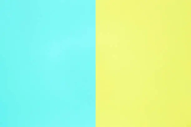 Photo of blue and yellow pastel color paper texture top view minimal flat lay background