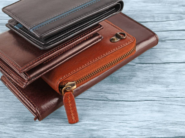 istock New leather multicolored wallets on light gray wooden background 1347925349