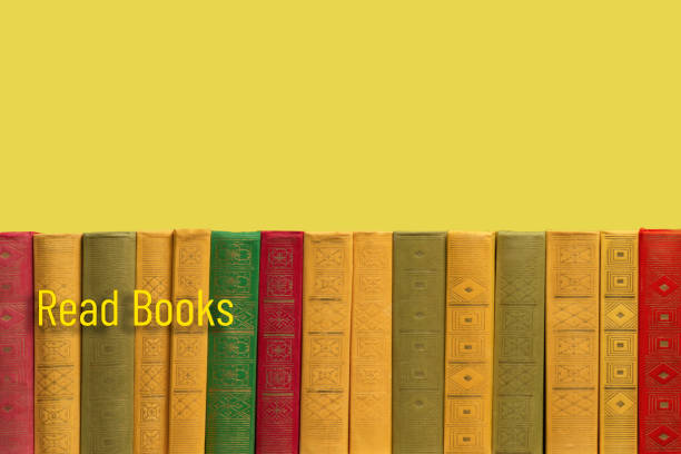 A hand picking a book from a bookshelf in a library