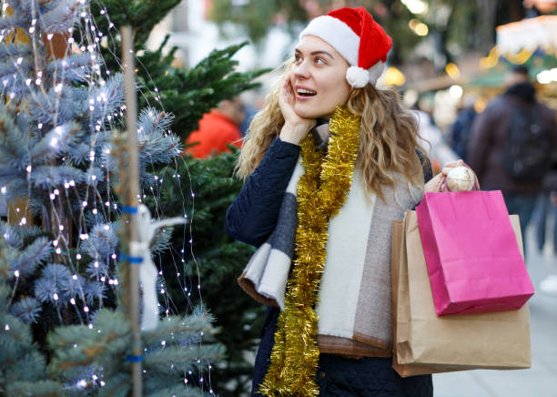 istock Woman buying Christmas tree 1347929032
