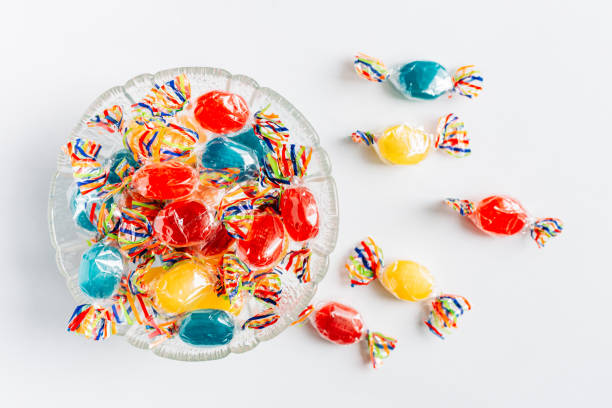 istock Bowl full with mix hard wrapped candies isolated on white background. 1347929397