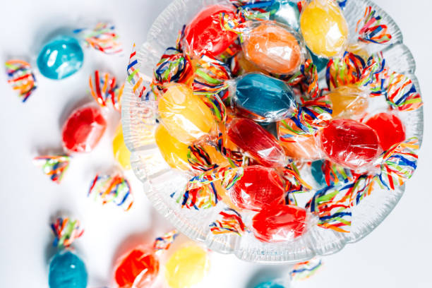 istock Bowl full with mix hard wrapped candies isolated on white background. 1347929529