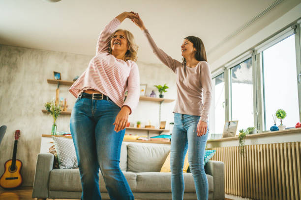 istock Smiling mother and daughter dancing 1347929780