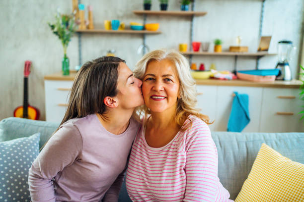 istock Daughter kissing her mother 1347930489