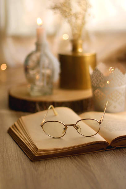 istock Book, Reading Glasses and Candles 1347930580