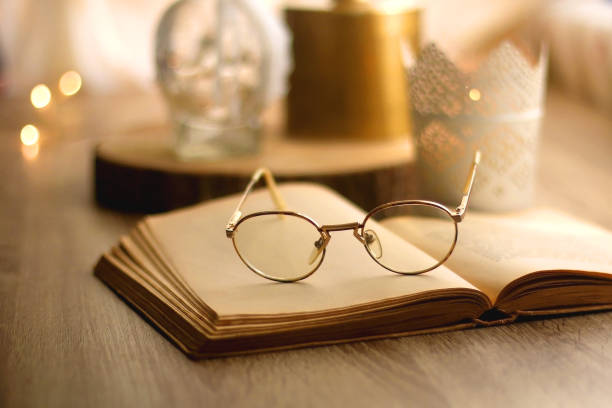 istock Book, Reading Glasses and Candles 1347930581