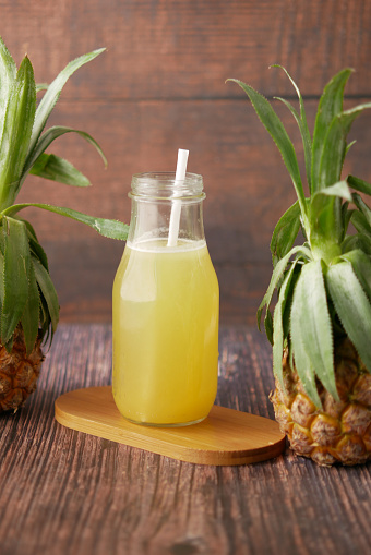 pineapple juice in a bottle on table .