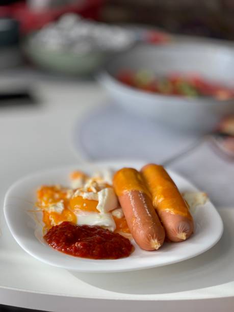 istock sausages with fried egg and sauce 1347932271