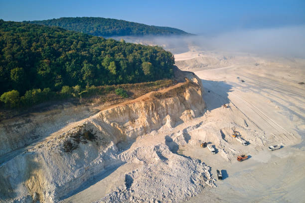 istock Aerial view of open pit mining site of limestone materials extraction for construction industry with excavators and dump trucks. 1347932349