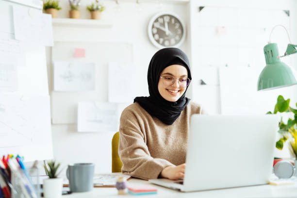 istock Middle Eastern woman working in office on laptop 1347933495