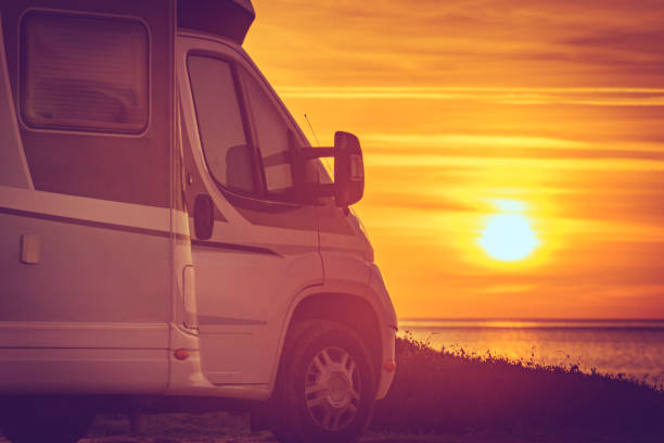 istock Camper vehicle on beach at sunrise 1347933544