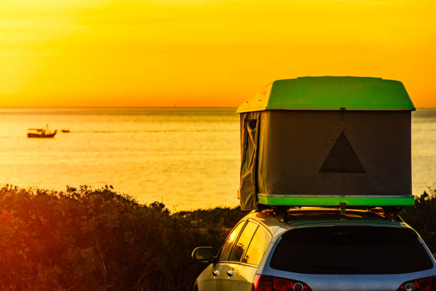 istock Car with roof top tent camp on beach 1347933954