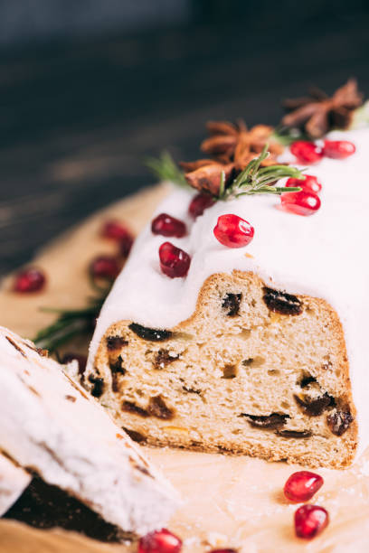 istock Christmas fruit cake with sugar powder on wooden board. 1347935471