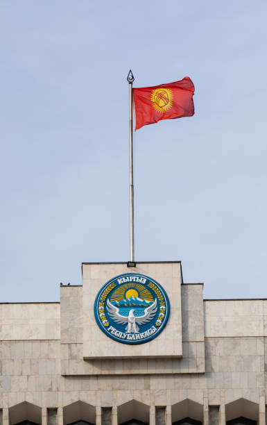 istock Kyrgyzstan flag waving on a flagpole with islamic star and crescent elements 1347937174