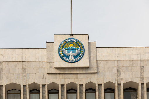Bishkek, Kyrgyzstan - October 21, 2021: National emblem of Kyrgyzstan on the building of The White House