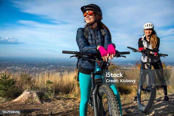 Two Young Women On A Ebike Ride Stock Photo - Download Image Now - Mountain Biking, Electric Bicycle, Women