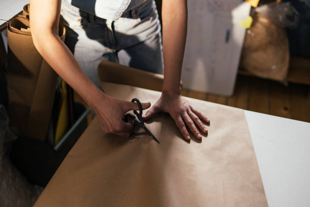 istock Anonymous Female Entrepreneur Working at her Storage Facility, Packing Goods for Shipping 1347940542