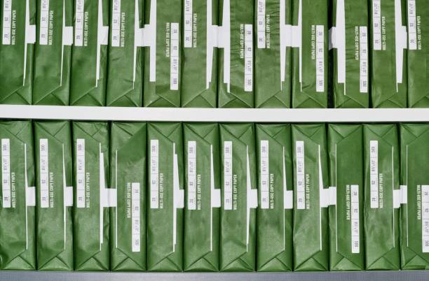 istock Copy paper reams with generic brand green packaging stacked up in rows. 1347941254