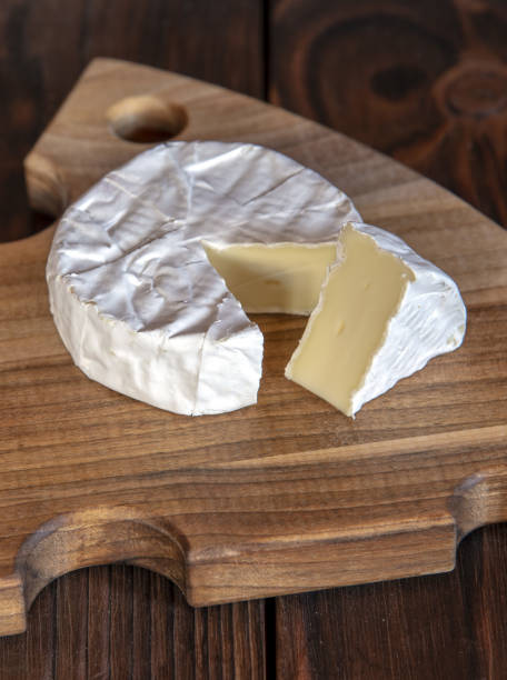 istock Cheese with white mold lies on a cutting board. 1347944099