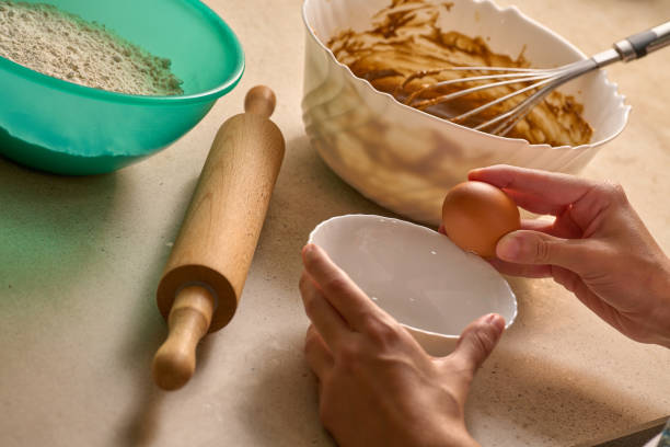 istock breaking egg in bowl to prepare cooking batter 1347946234
