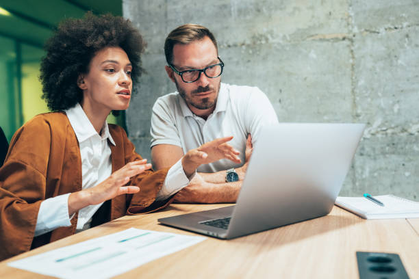 istock Two business people working together in office 1347947373