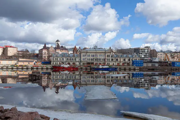 Panorama of the embankment with ancient beautiful buildings of the mid-century city of Vyborg in Russia on a spring sunny day.