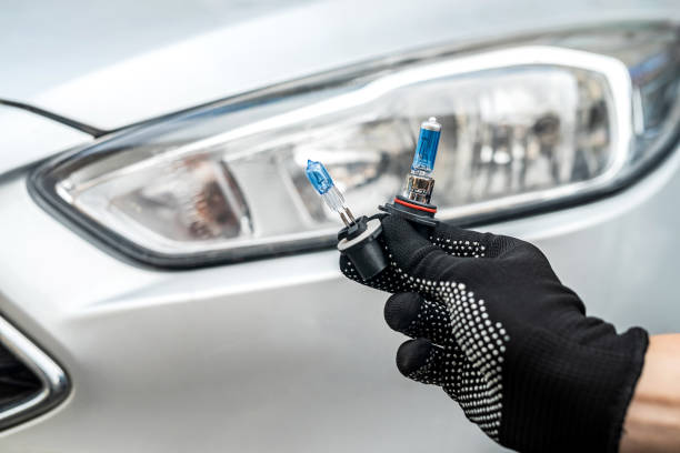 istock service machanic holds h7 halogen light bulb against of headlight 1347951256