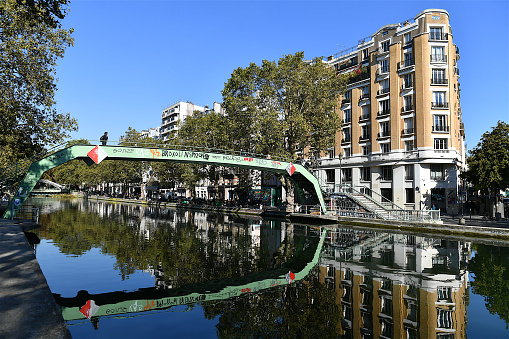 Paris, France-10 14 2021:People crossing a footbridge over the Saint-Martin canal in Paris, France.