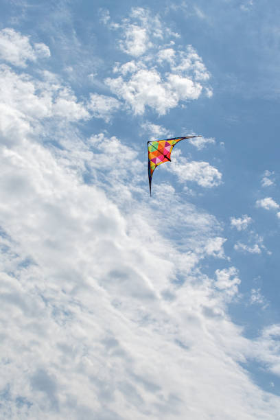 istock Kite flying in the sky with clouds 1347952789