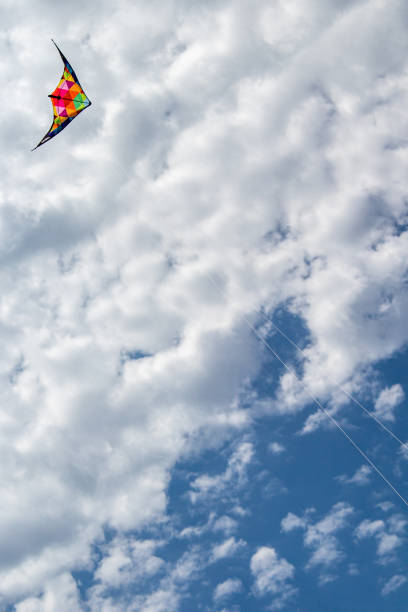 istock Kite flying in the sky with clouds 1347952796