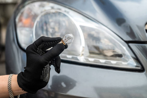 istock mechanic change low-beam or high-beam light bulb in his car 1347952987